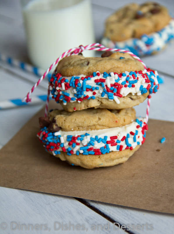 Chocolate Chip Cookie Ice Cream Sandwiches on a cutting board with a glass of milk.