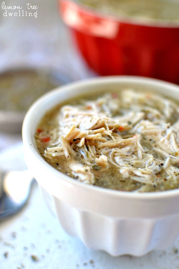 Crock Pot Italian Chicken in a white bowl with a spoon.