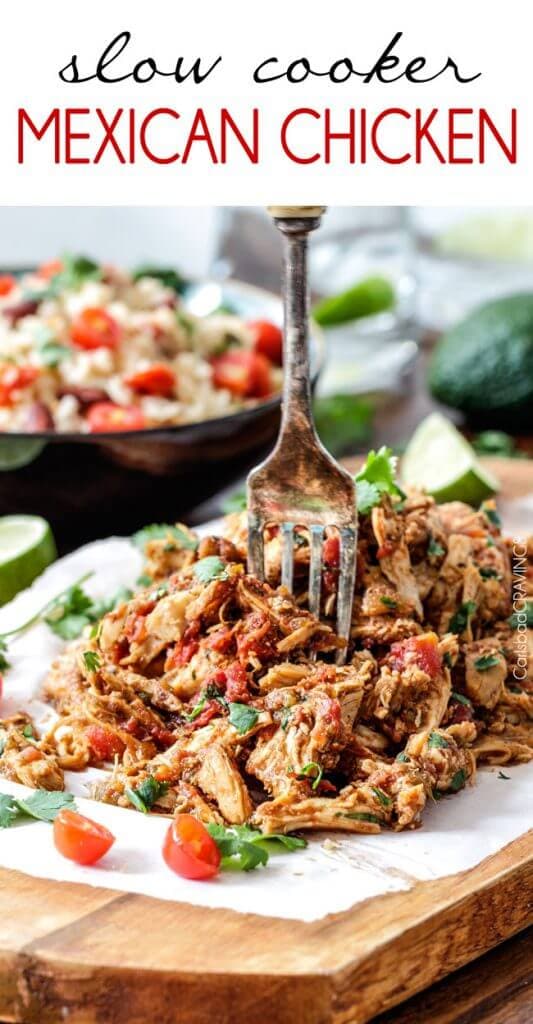 Slow Cooker Mexican Chicken on a cutting board with a fork.