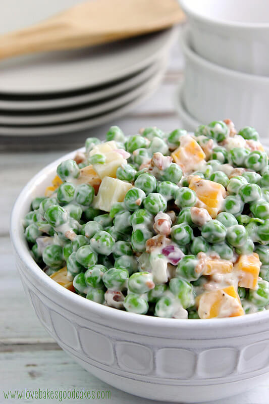 Creamy Pea Salad in a white bowl for memorial day.