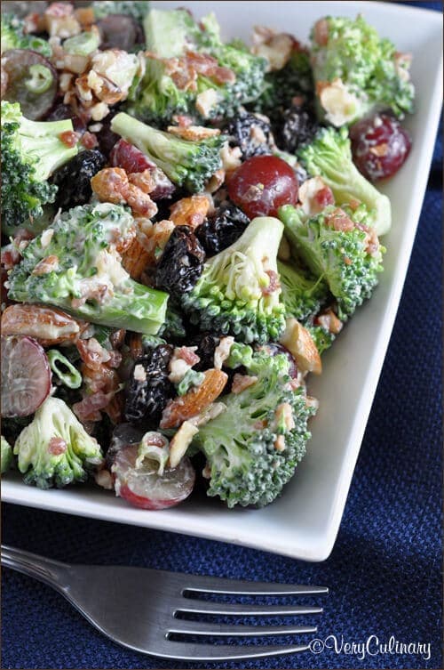 Broccoli Salad in a white bowl with a fork.