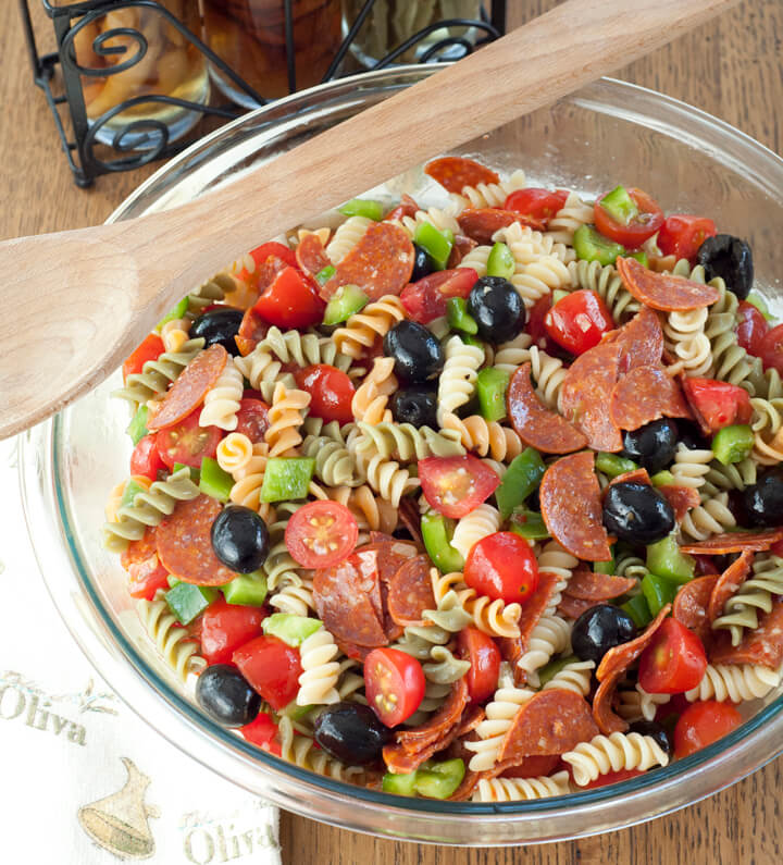 Classic Italian Pasta Salad in a glass bowl with a spoon.