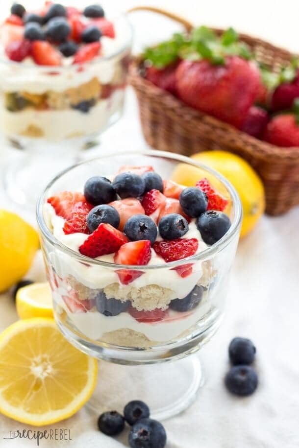 Lemon Cheesecake Trifles in glass bowls with fresh fruit.