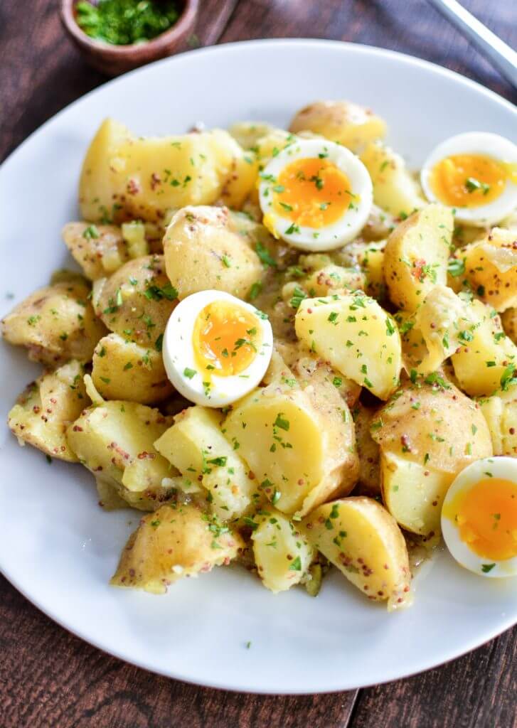 Potato Salad with Soft-Boiled Eggs and Maple Mustard Dressing on a white plate.
