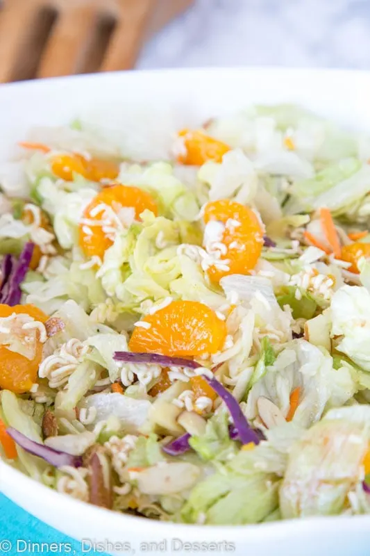 A bowl of food on a plate, with Salad and Dinner