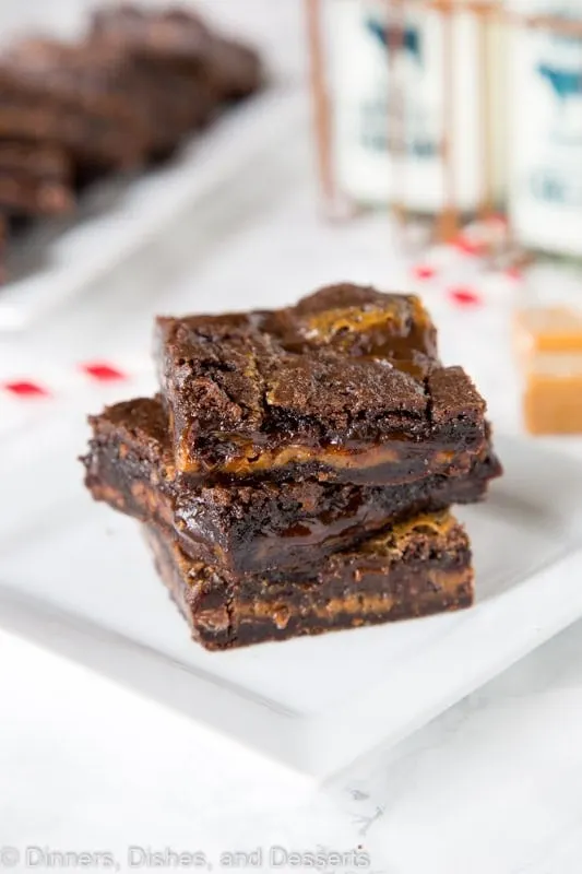chocolate caramel brownies stacked on a plate