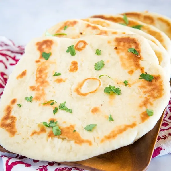 Naan Bread - This homemade naan bread is a soft and chewy Indian style flatbread.  A simple and easy dough that makes for the most delicious bread!  It is great to brush with butter and garlic for an easy garlic naan recipe.