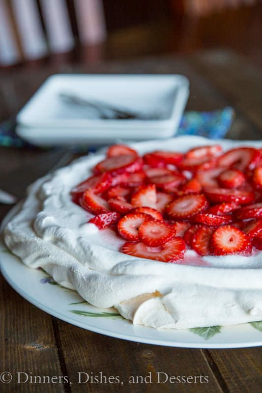 Strawberry Pavlova on a plate with green leaves