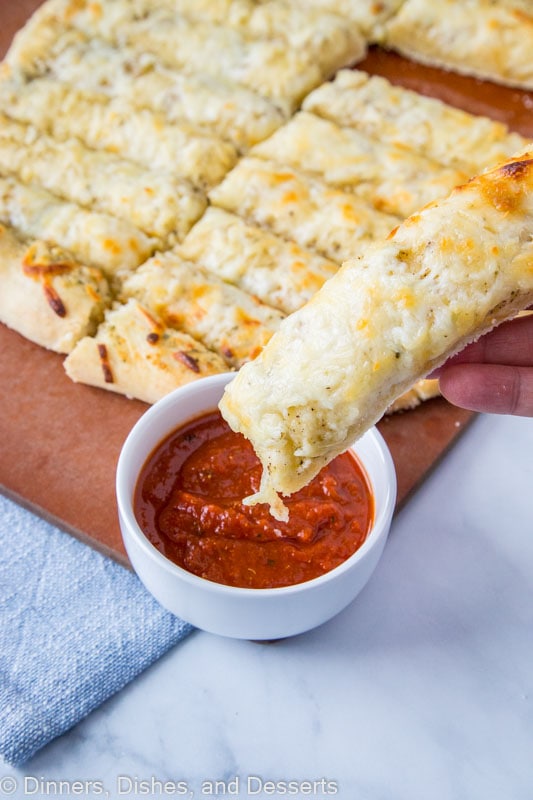 Cheese Breadsticks dipping in pizza sauce