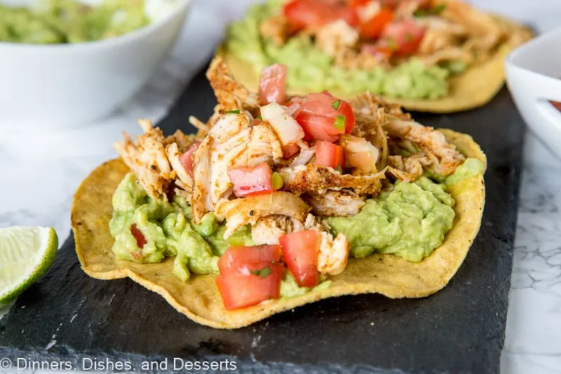 chicken tostada with guacamole on a plate