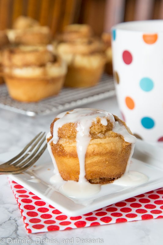 cinnamon roll muffin on a plate with vanilla glaze