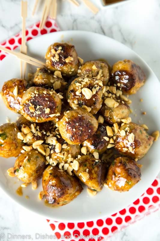 a plate of chicken meatballs with chopped peanuts