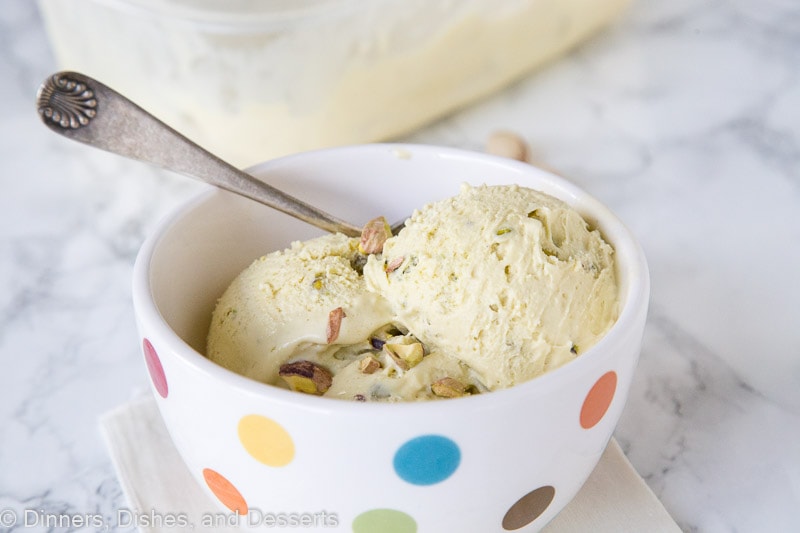 A bowl pistachio ice cream with a spoon