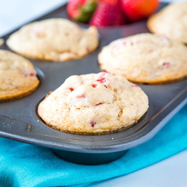 Strawberry Muffins - a quick and easy muffin recipe with lots of fresh juicy strawberries.  Slightly sweet, tender and absolutely delicious.  Great to freeze and have on hand for busy mornings!