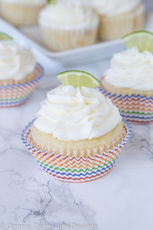 margarita cupcakes topped with frosting and a lime slice