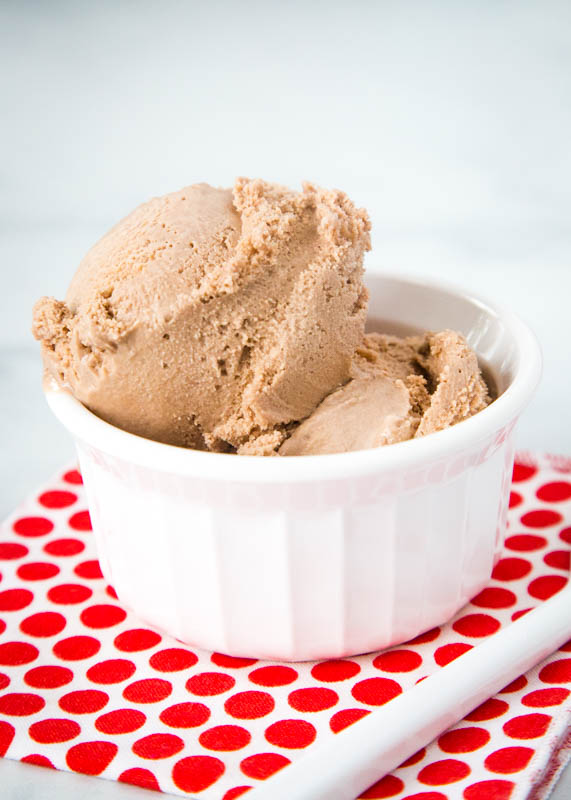 homemade chocolate ice cream in a white bowl with white and red napkin