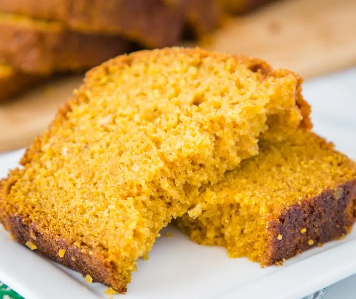 A close up of a slice of  punpkin bread on a plate