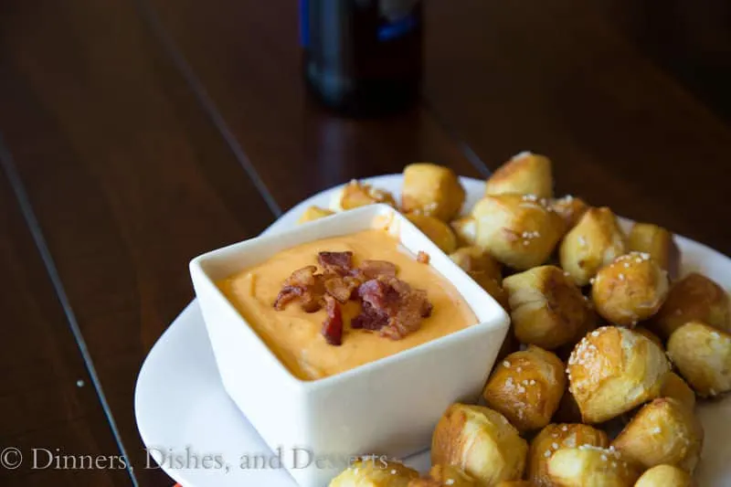beer cheese dip in a bowl with pretzel bites