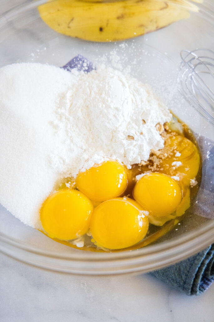 A bowl with sugar, cornstarch, eggs, and vanilla