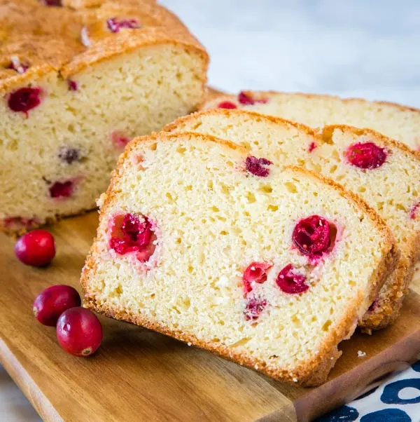 A piece of cake on a plate, with Bread and Cranberry