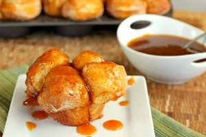 Pumpkin Caramel Monkey Bread Muffins with bowl of caramel in background