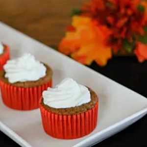 pumpkin pie cupcakes on white plate with orange leaves in the background