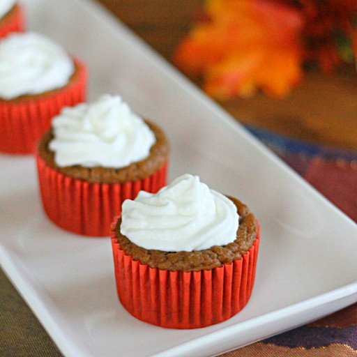 Pumpkin Pie Cupcakes on white plate with whipped cream on top