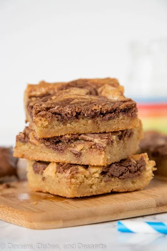 Blondies swirled with nutella stacked on a cutting board