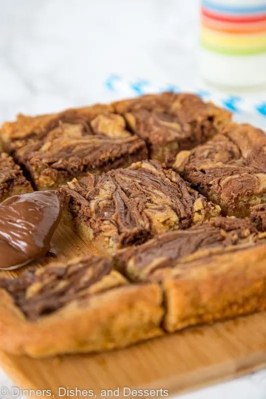 Blondies swirled with nutella on a cutting board