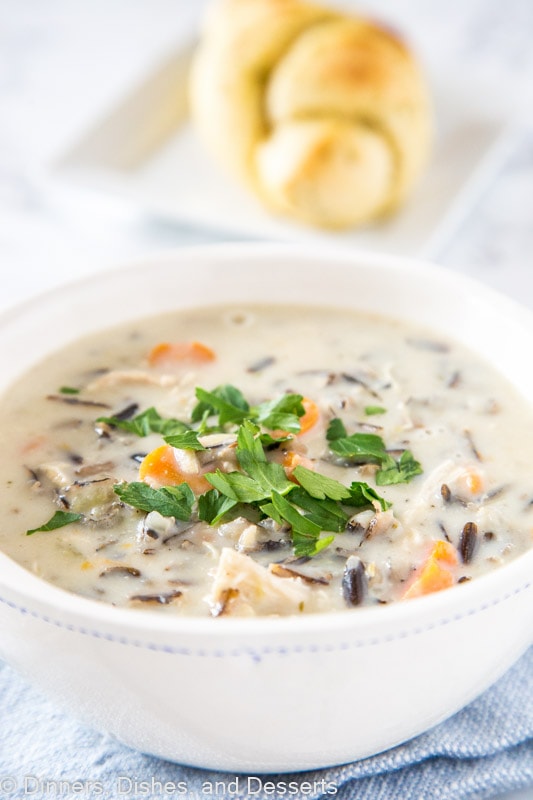 A bowl of food on a plate, with Soup and Wild rice