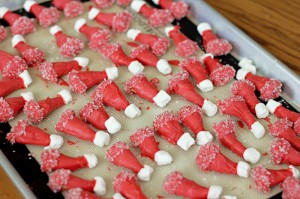 Santa Hats - bugles dipped in red chocolate with marshmallow tip on baking sheet 