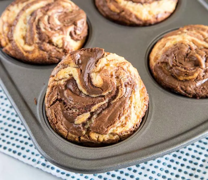 Nutella Muffins - Soft and tender homemade muffins with a delicious swirl of Nutella.