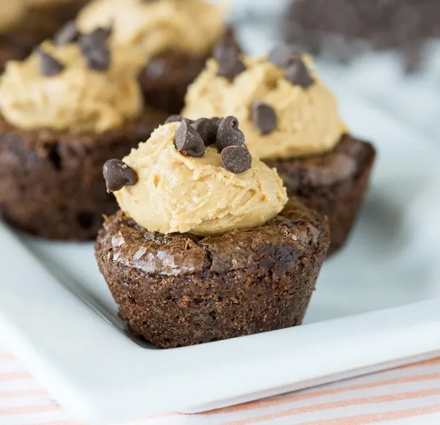 A close up of brownies topped with peanut butter and chocolate chips