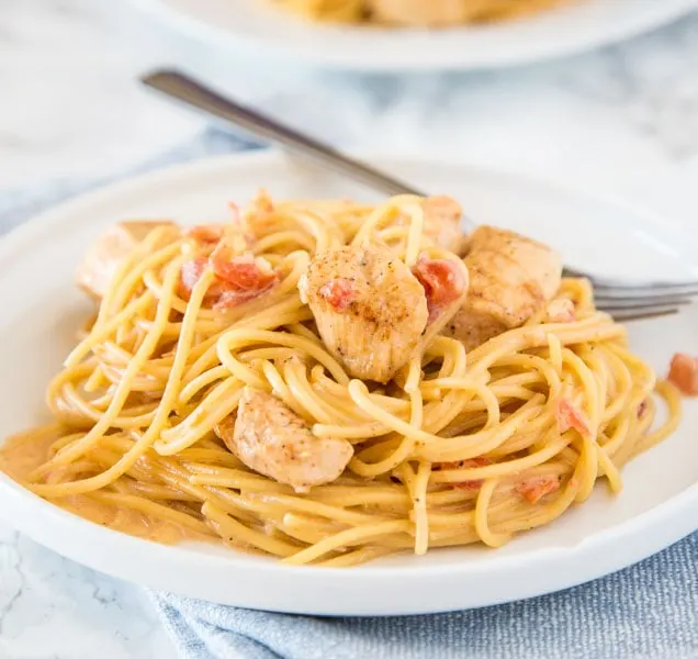 Creamy Cajun Chicken Pasta - Get dinner on the table fast with this creamy pasta full of spicy creole seasoning, tomatoes, and chicken!  