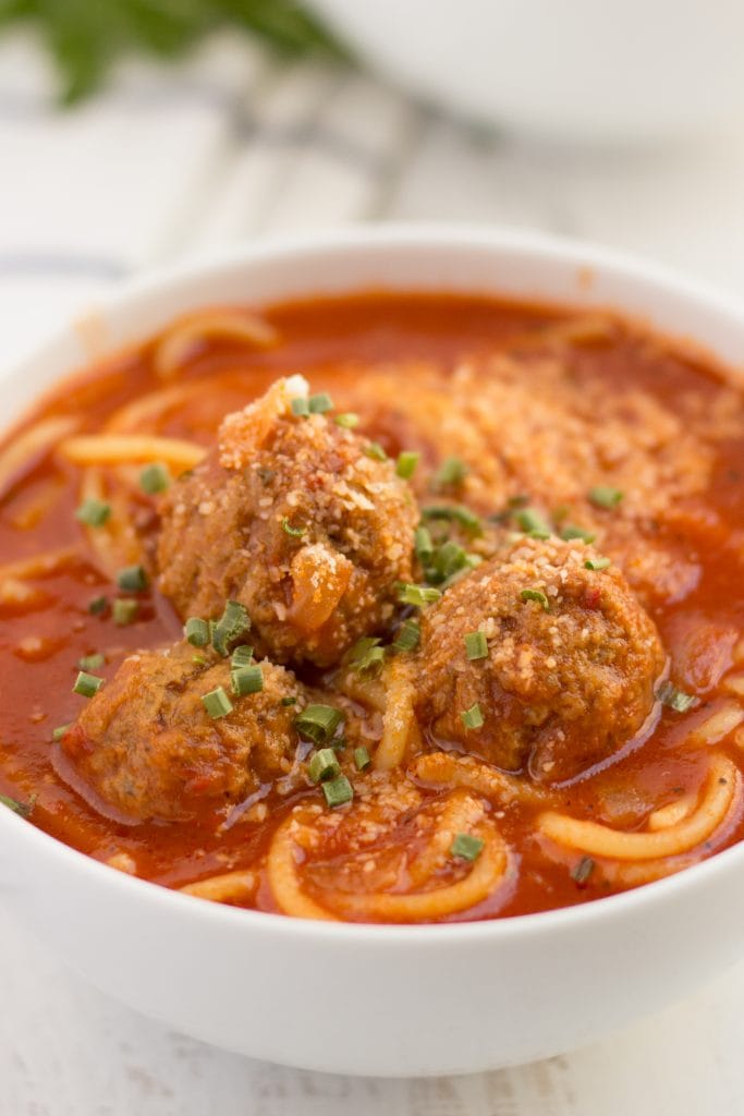 spaghetti and meatball soup in a bowl