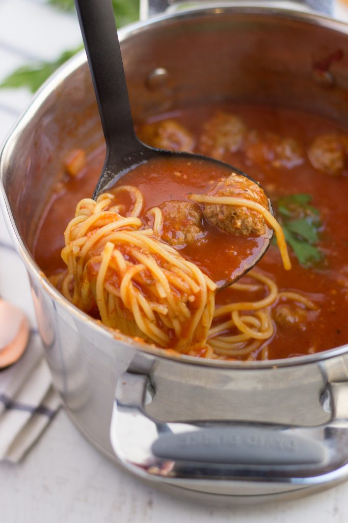 spaghetti and meatball soup in a pot
