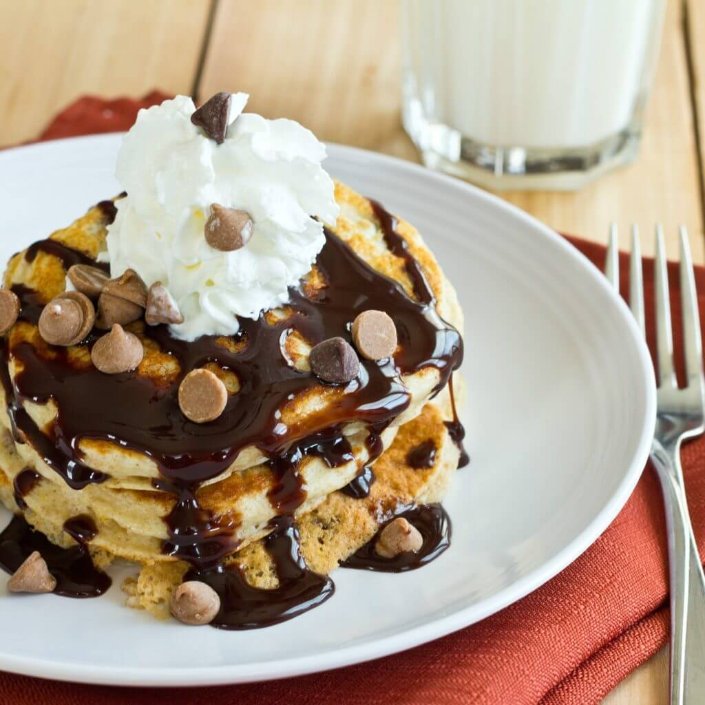 Peanut Butter Chocolate Chip Pancakes - Light and fluffy buttermilk pancakes topped with peanut butter, chocolate sauce, and whipped cream! It is like dessert for breakfast!