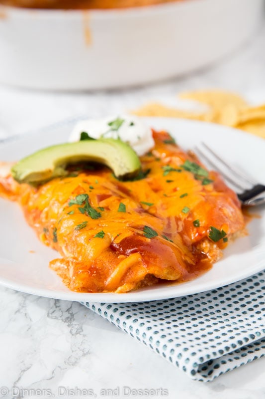 A plate of food on a table, with Enchilada and Cream