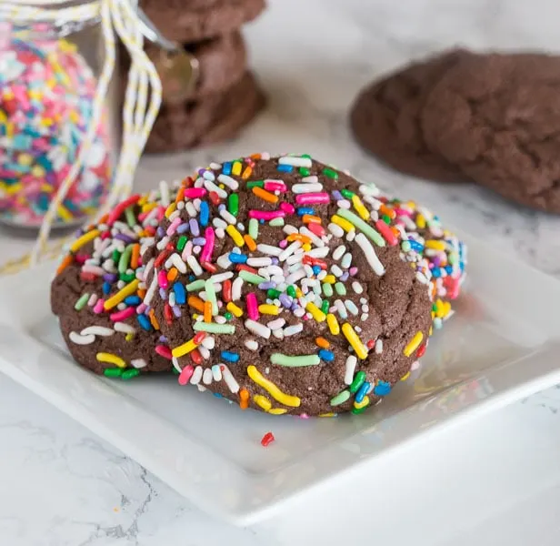 Chocolate Sprinkle Cookies - chocolate cookies from cake mix are super easy to make! Just 3 ingredients to make these thick, chewy, and fudgy cookies.  Coated in fun sprinkles for any occasion.