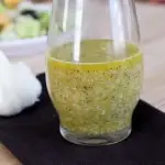 Roasted Garlic Vinaigrette in glass jar on black napkin