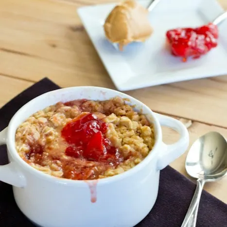 cloes up peanut butter and jelly baked oatmeal in a white bowl