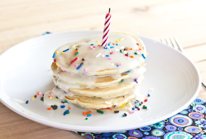funfetti pancakes on a plate with a candle in the top