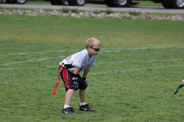 A boy playing football on a field