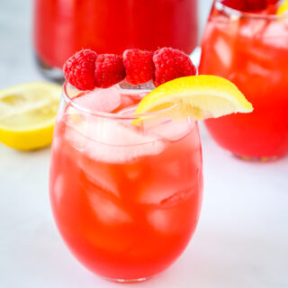Raspberry Lemonade - Pureed raspberries give fresh squeezed lemonade such a great new flavor!  So easy to make and the perfect refreshing summer drink!