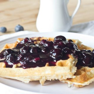 waffles on a plate with blueberry sauce