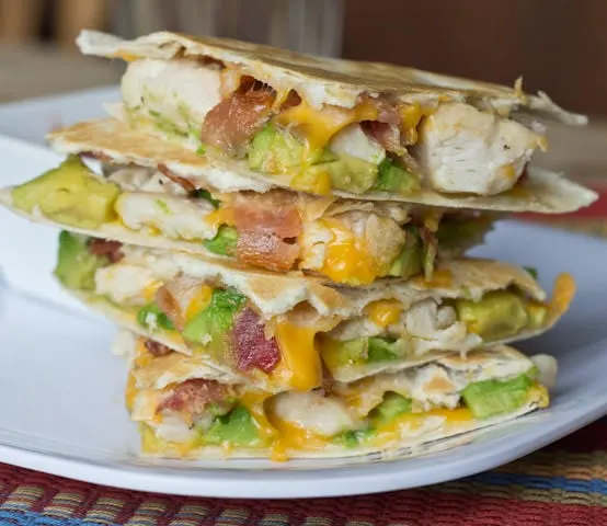 Quesadillas are a very versatile easy dinner to get on the table. This version is filled with crispy bacon, chicken, and buttery avocado. Great for busy school nights.