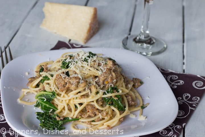 spaghetti with kale and sausage on a plate