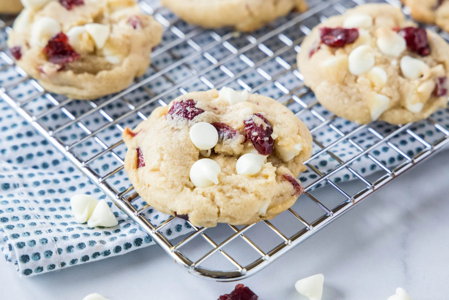 White chocolate cranberry cookies cooling on a wire rack