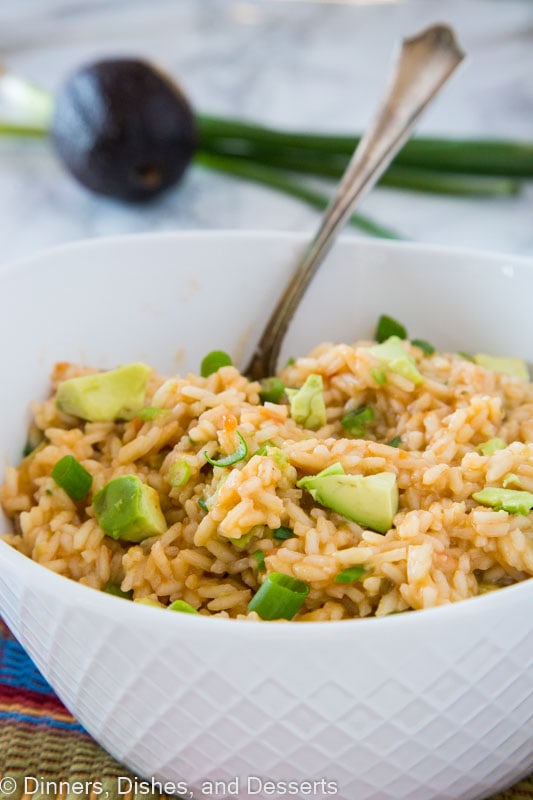 a bowl of mexican rice with a spoon