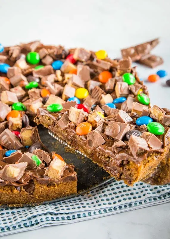 Dessert pizza made with chocolate chip cookies and all sorts of candy